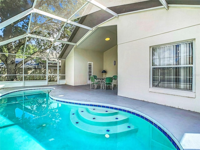 view of swimming pool with a lanai and a patio