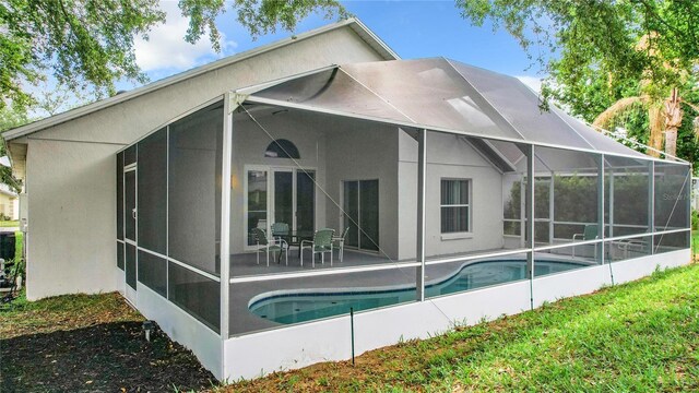 rear view of property with a patio area and a lanai