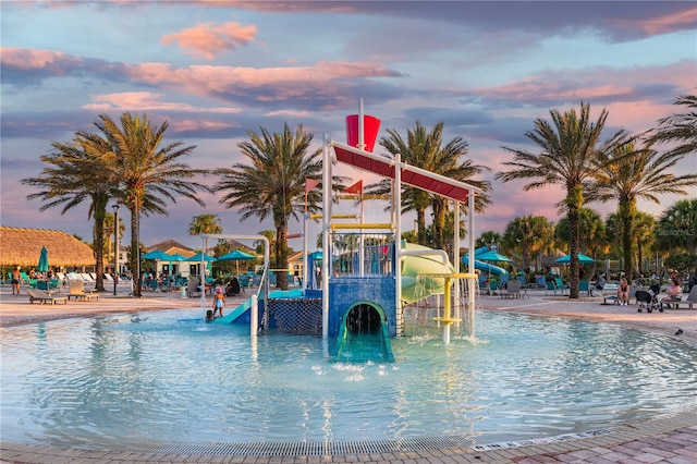 pool at dusk with a playground