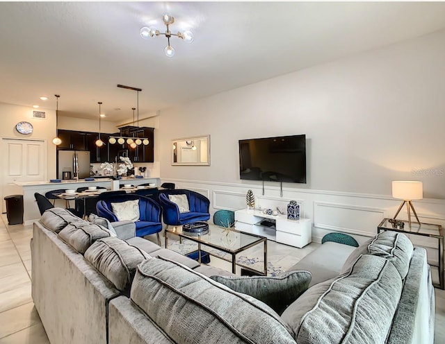 tiled living room with an inviting chandelier