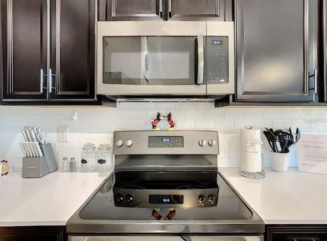 kitchen featuring backsplash, dark brown cabinetry, and stainless steel appliances