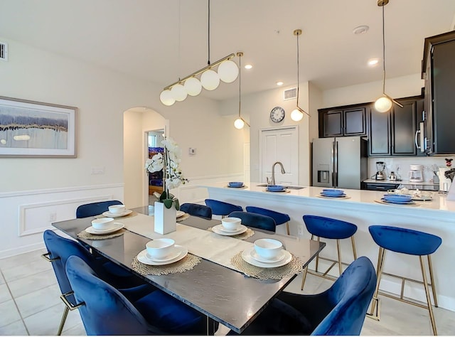 dining area featuring light tile patterned floors and sink