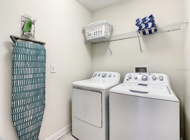 clothes washing area with washing machine and clothes dryer