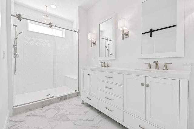 full bath with a shower stall, double vanity, marble finish floor, and a sink