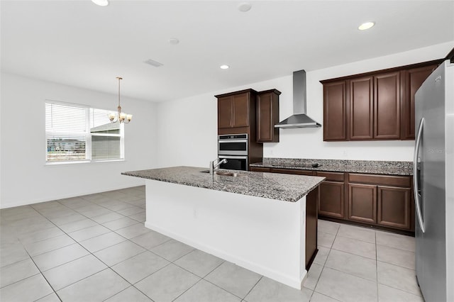 5115 Lake Hamlin Trl, Winter Garden, FL 34787 - kitchen featuring wall chimney range hood, light tile flooring, stainless steel appliances, hanging light fixtures, and a center island with sink