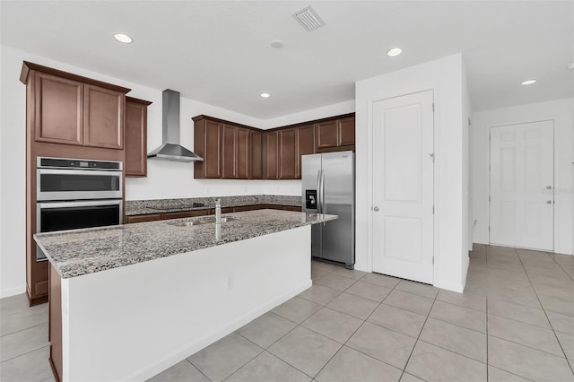 5115 Lake Hamlin Trl, Winter Garden, FL 34787 - kitchen with stainless steel appliances, light tile floors, wall chimney range hood, sink, and a kitchen island with sink