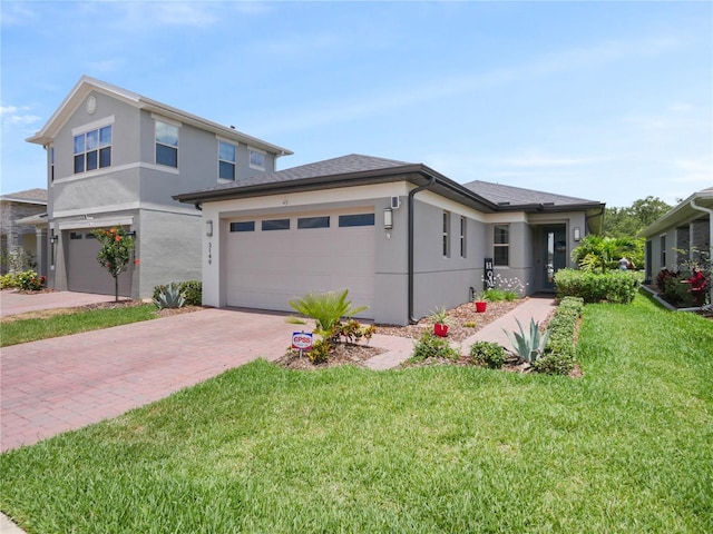 view of front facade with a front yard and a garage