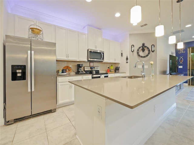 kitchen with white cabinetry, a center island with sink, appliances with stainless steel finishes, backsplash, and light tile flooring