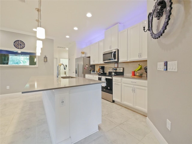 kitchen featuring white cabinetry, appliances with stainless steel finishes, sink, and decorative light fixtures