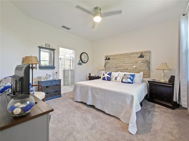 bedroom featuring carpet, ensuite bath, and ceiling fan