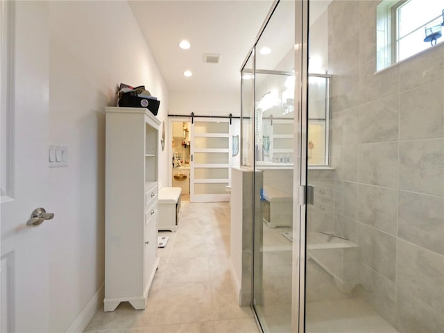 bathroom featuring tile floors, an enclosed shower, and vanity