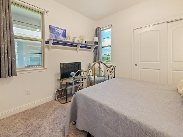 carpeted bedroom featuring a closet