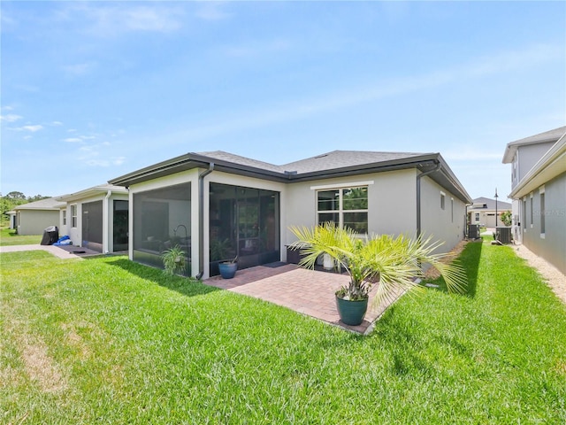 back of property featuring a patio area and a lawn