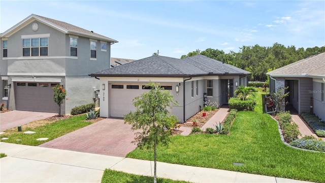 view of front of home featuring a garage and a front lawn