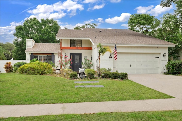 view of front of house featuring a front lawn and a garage