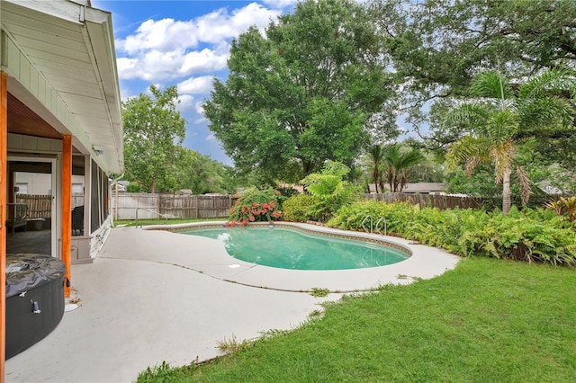 view of swimming pool with a patio area and a yard