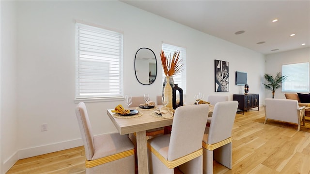 dining space with light hardwood / wood-style floors