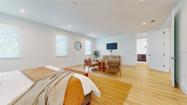 bedroom featuring light hardwood / wood-style floors and multiple windows