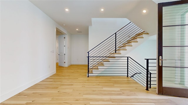 staircase with hardwood / wood-style flooring