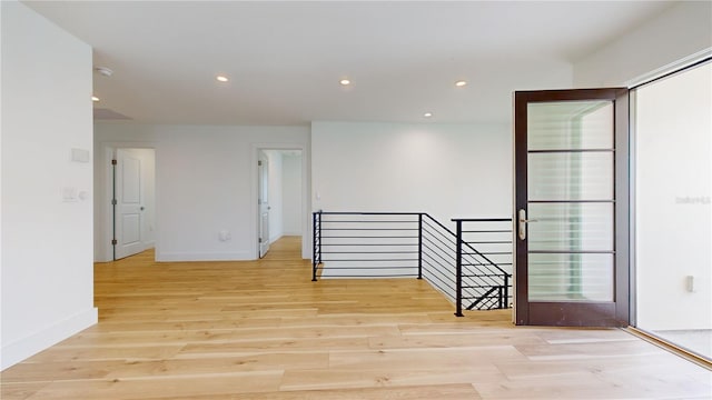 unfurnished room with light wood-type flooring