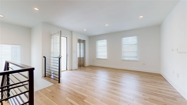 empty room with light hardwood / wood-style flooring