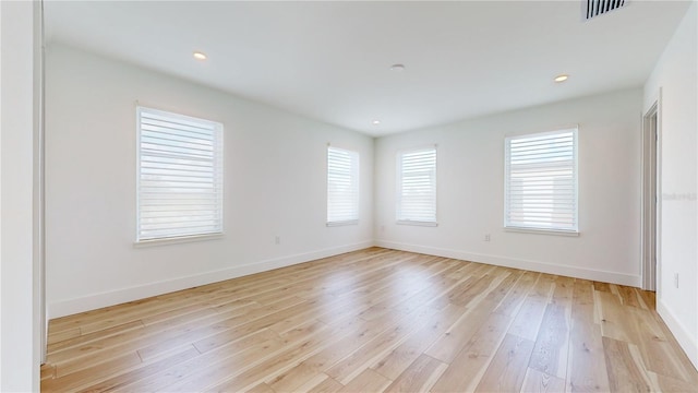 unfurnished room with light wood-type flooring