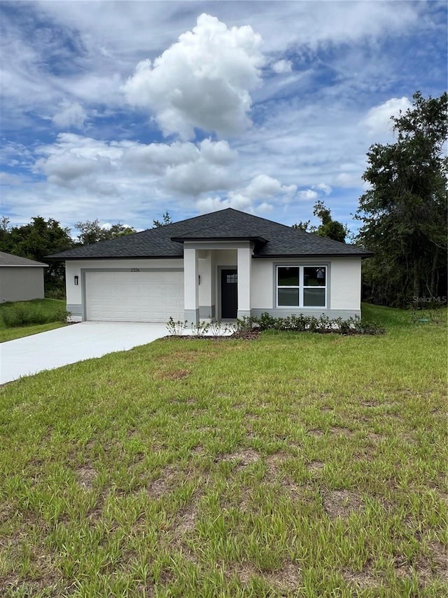 view of front of house with a garage and a front yard