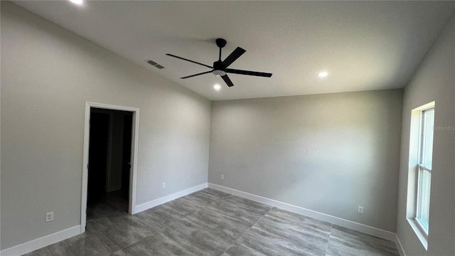 unfurnished room featuring ceiling fan, a healthy amount of sunlight, and vaulted ceiling