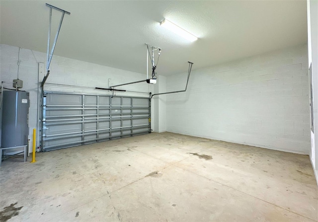 garage featuring a garage door opener and water heater