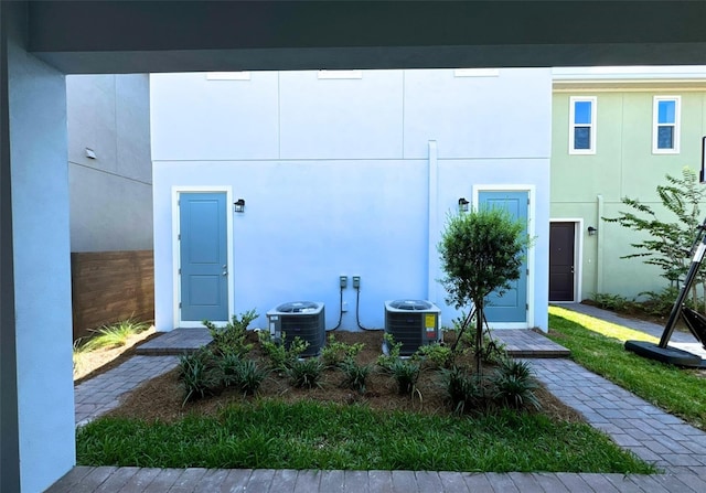 doorway to property featuring central air condition unit