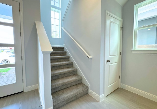 stairs featuring hardwood / wood-style flooring