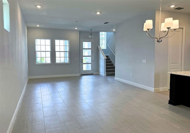 empty room featuring an inviting chandelier