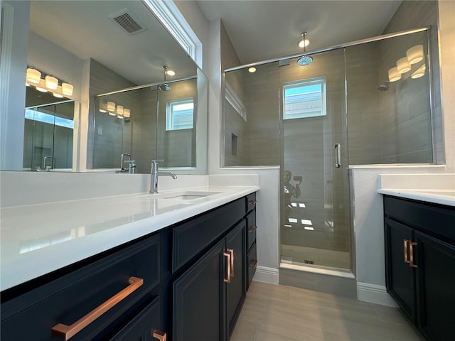 bathroom featuring vanity and an enclosed shower