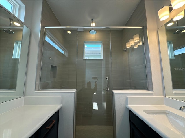 bathroom with walk in shower and vanity