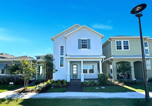 view of front facade featuring a front yard and covered porch