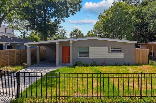 view of front of house with a front yard and a carport