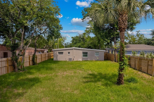 view of yard with central AC and a fenced backyard