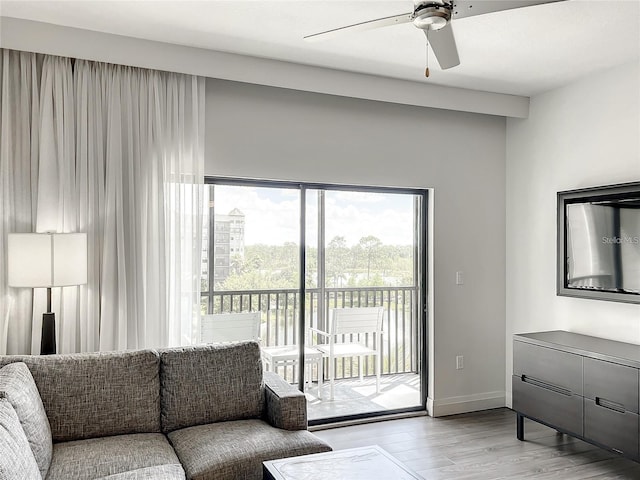 living room featuring light hardwood / wood-style floors and ceiling fan