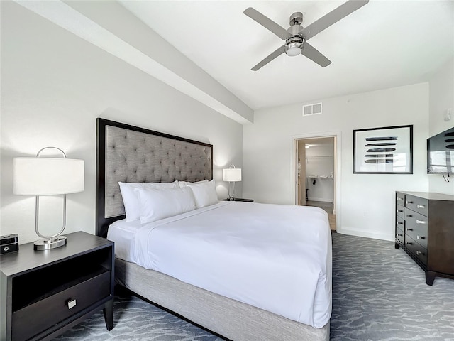 carpeted bedroom featuring ceiling fan and a spacious closet