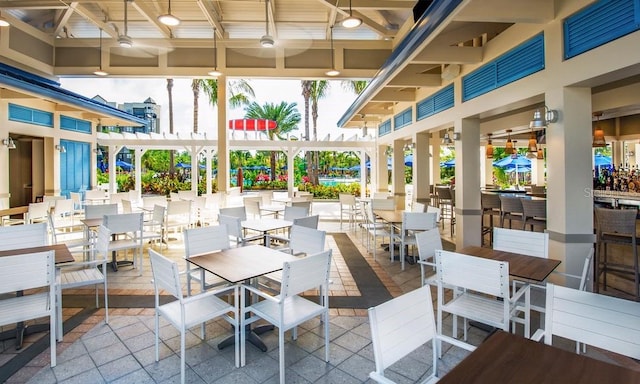 view of patio / terrace with ceiling fan and an outdoor bar