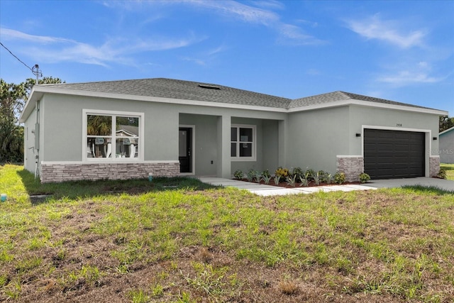 view of front facade with a front yard and a garage