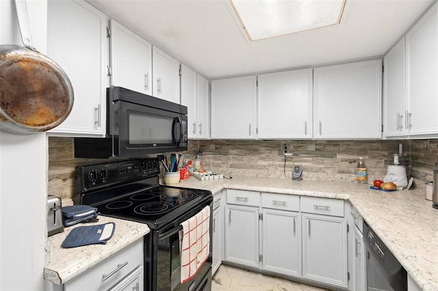 kitchen with white cabinetry, black appliances, backsplash, and light tile flooring