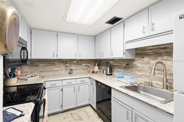 kitchen with sink, tasteful backsplash, black appliances, and light tile floors