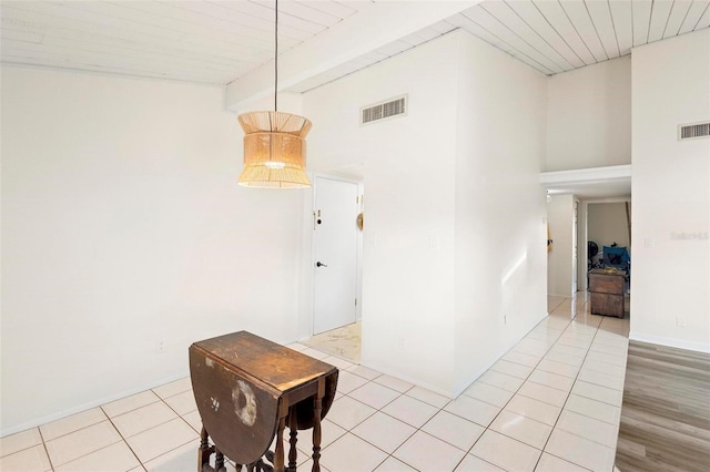 dining area with beam ceiling, high vaulted ceiling, and wood-type flooring