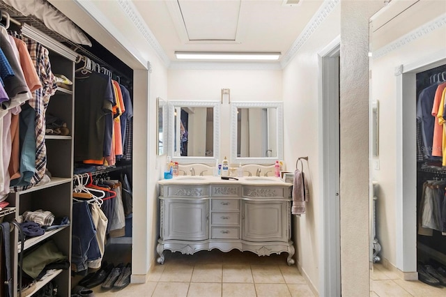 walk in closet featuring sink and light tile floors