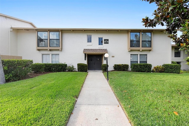 view of property featuring a front lawn