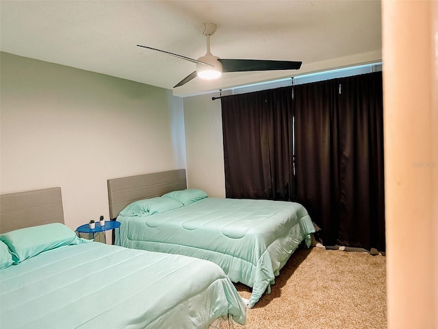 bedroom featuring ceiling fan and light carpet