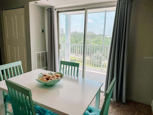 carpeted dining room with floor to ceiling windows