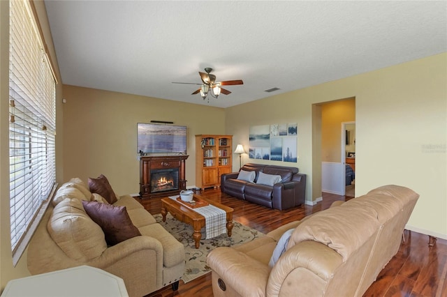 living room with ceiling fan and dark hardwood / wood-style floors