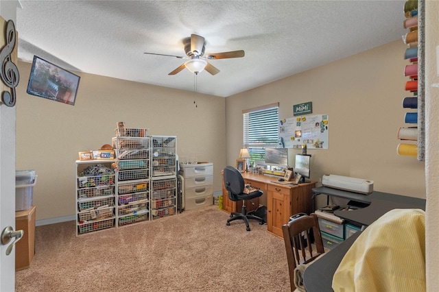 carpeted office space featuring a textured ceiling and ceiling fan